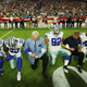 Dallas Cowboys players and staff members, including owner Jerry Jones and head coach Jason Garrett, all take a knee before the singing of the National Anthem before the start of a game against the Arizona Cardinals at University of Phoenix Stadium on Monday (Andy Jacobsohn/Dallas Morning News)